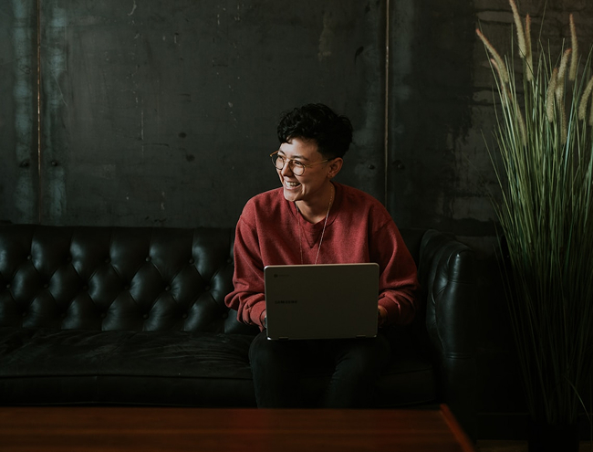 Woman with glasses looking at laptop