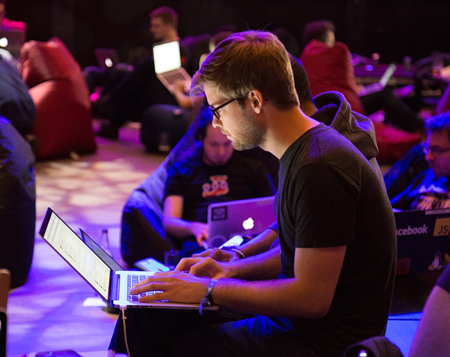 Man with glasses looking at laptop