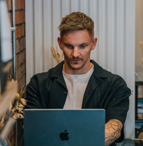 Man with beard on laptop